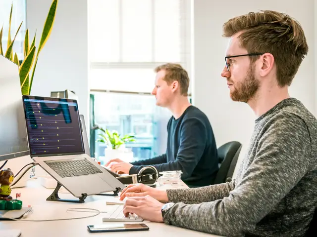 Modern fintech workplace with team and screens.